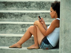 A Cuban young woman uses her mobile phone in Havana.  STR/AFP/Getty Images Creative Commons License