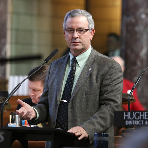 Older white man with gray hair in suit (senator Dan Hughes)