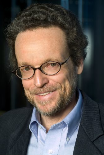 Facial profile of caucasian man in dress shirt and jacket with glasses.