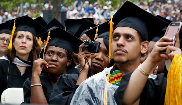 Image depicts graduating students listening to a commencement address in New York in 2016.