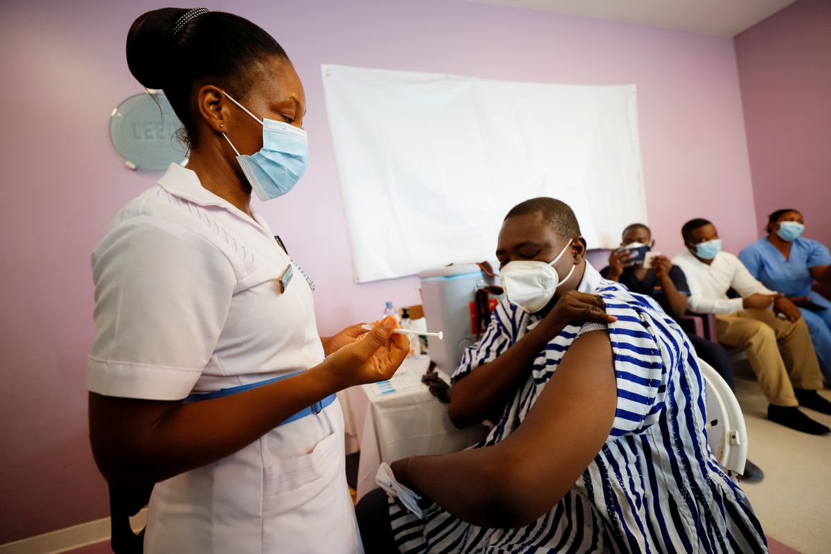 A healthcare worker receives the COVID-19 vaccine in Accra, Ghana